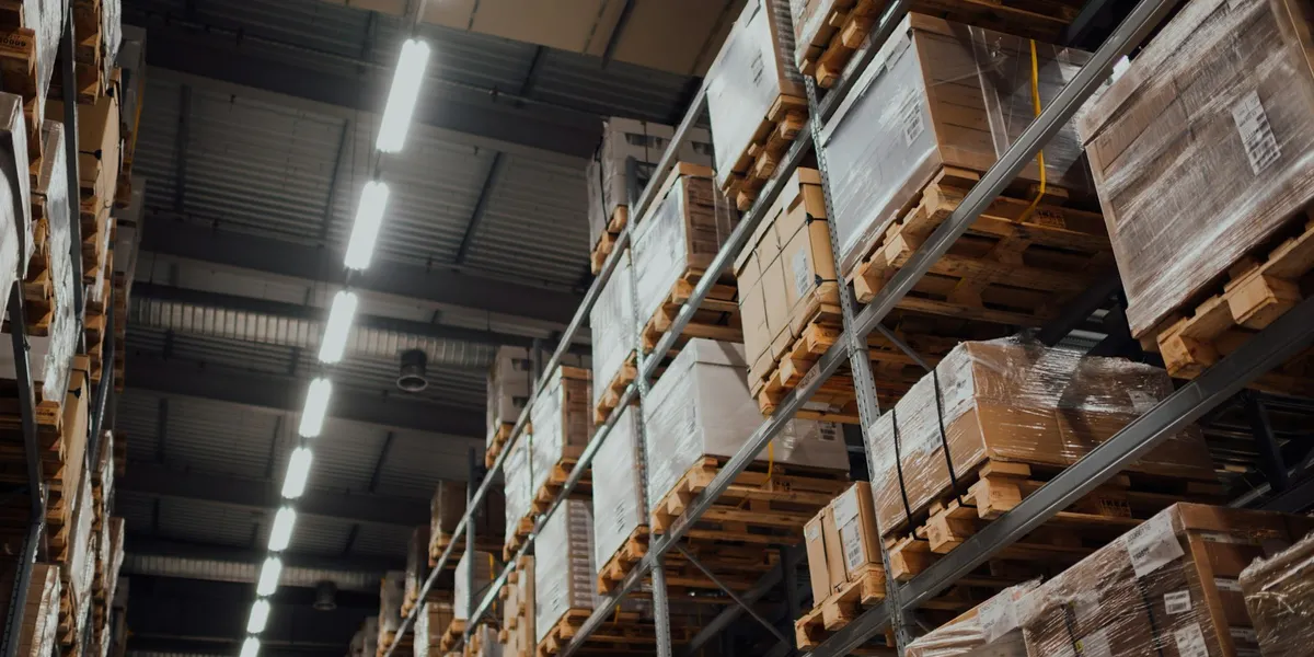 brown cardboard boxes on white metal rack